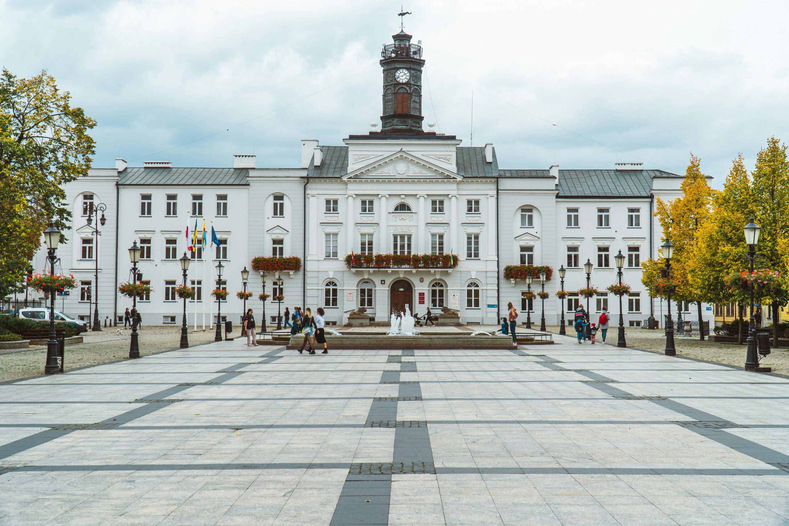View of the historic town hall in Plock, Poland, showcasing classic architecture and city square.